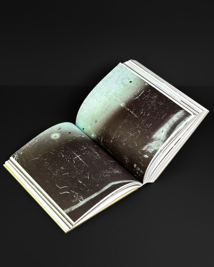 Open spread from Mark Borthwick Out of Date with large dark photographic imagery across both pages.