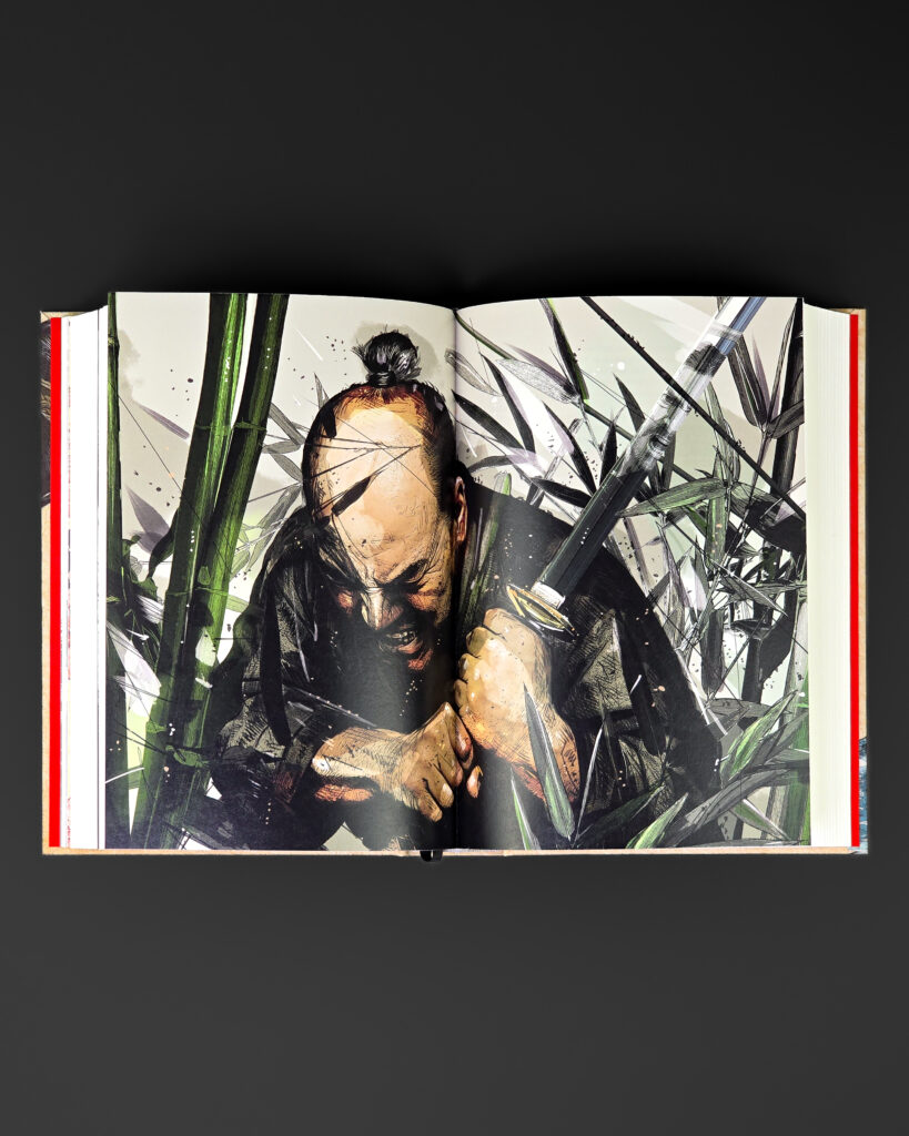 Open Shōgun volume displaying a full-colour double-page illustration by Chris Malbon.