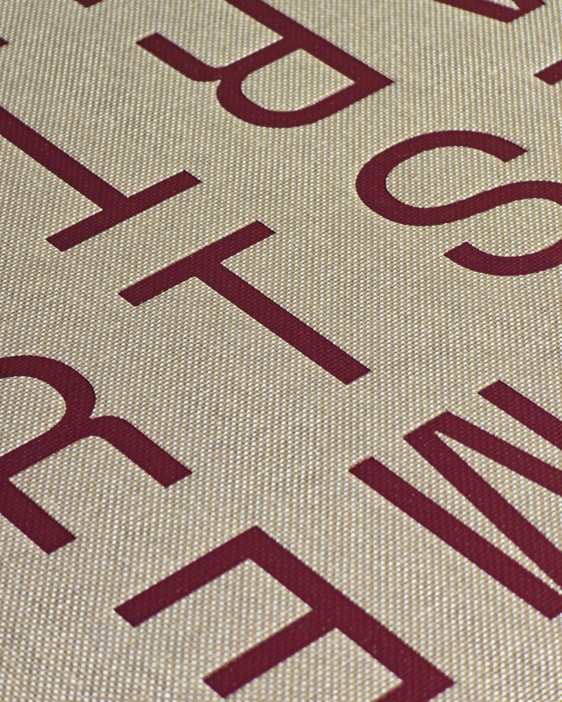 Macro detail of the woven cloth cover and burgundy title of Vacheron Constantin: Time is Art.