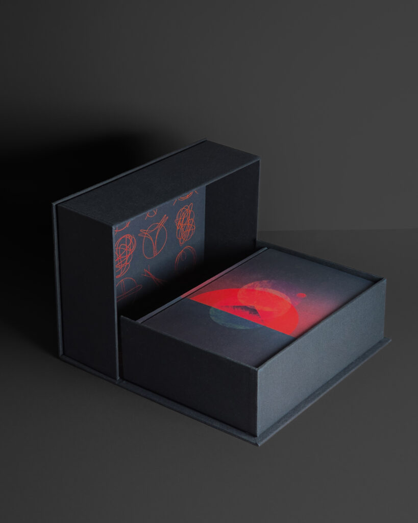 Open clamshell case of The Three-Body Problem Trilogy limited edition showing the book inside.
